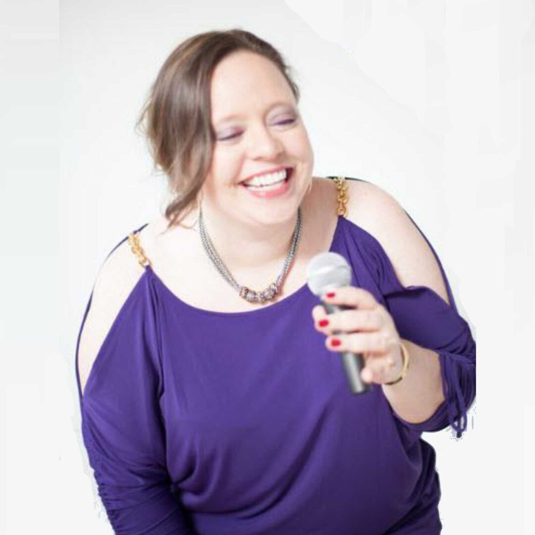 A woman wearing purple dress holding a mike with white background